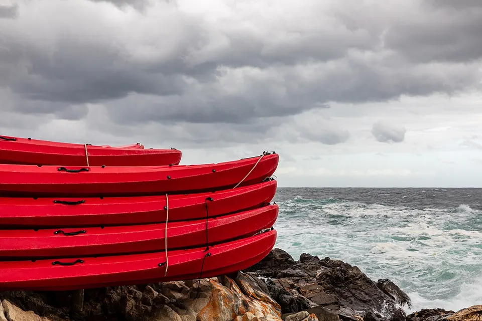 Red kayaks beside the ocean on the Garden Route